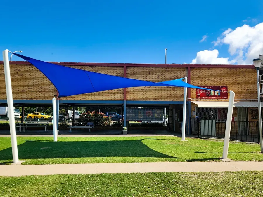 Blue shade sail shading a lawn area outside a commercial building - New England Shade Sails, Tamworth