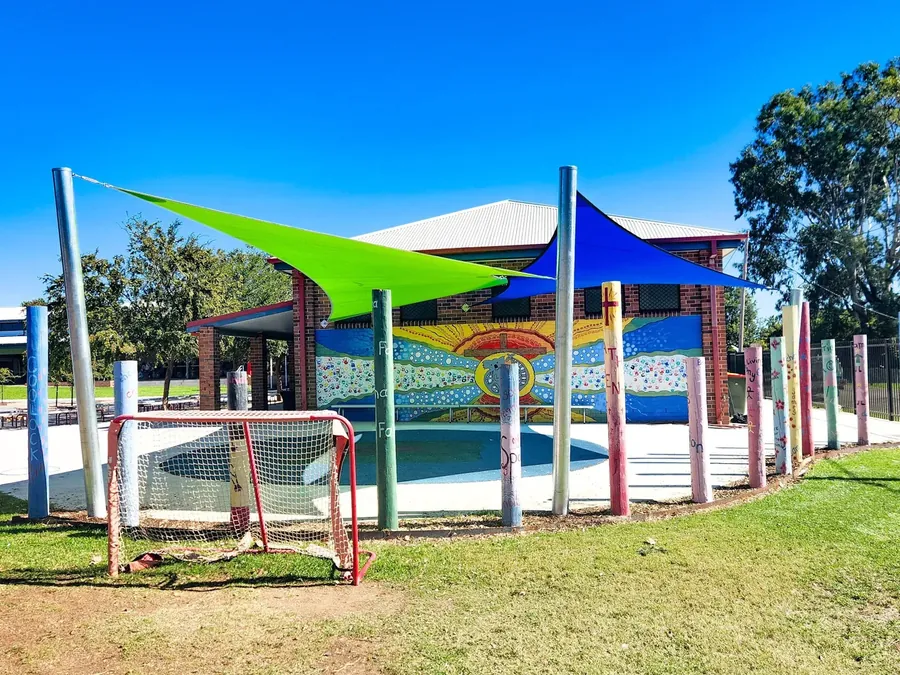 Green and blue shade sails over colourful playground equipment - New England Shade Sails, Tamworth