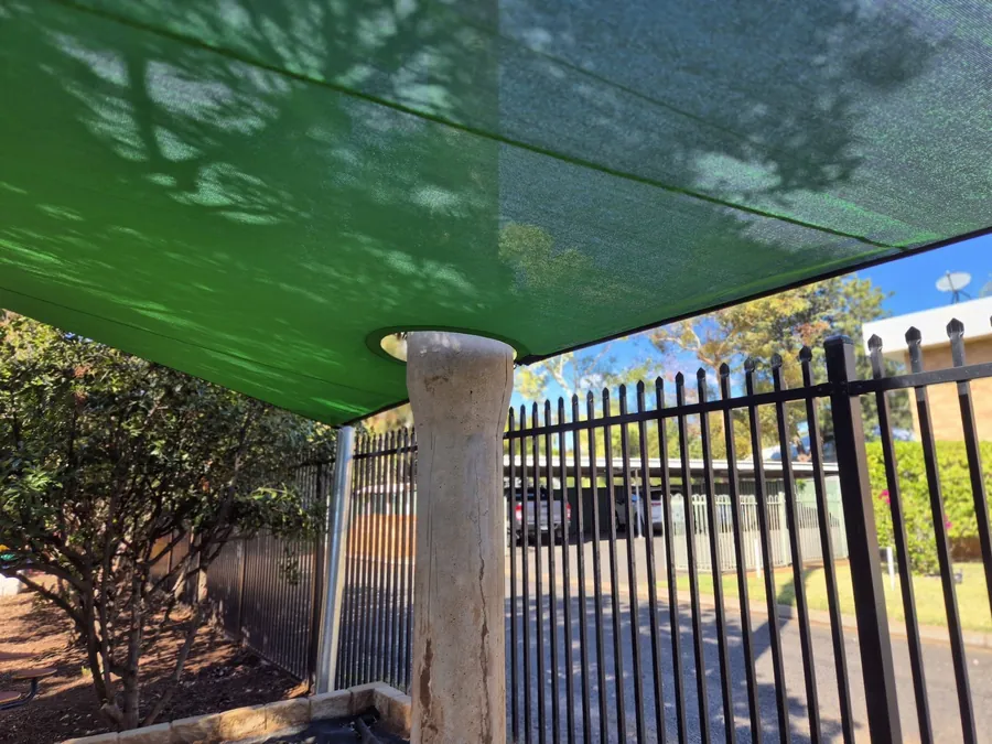 Green shade sail shading a fenced covered walkway at a community facility - New England Shade Sails, Tamworth