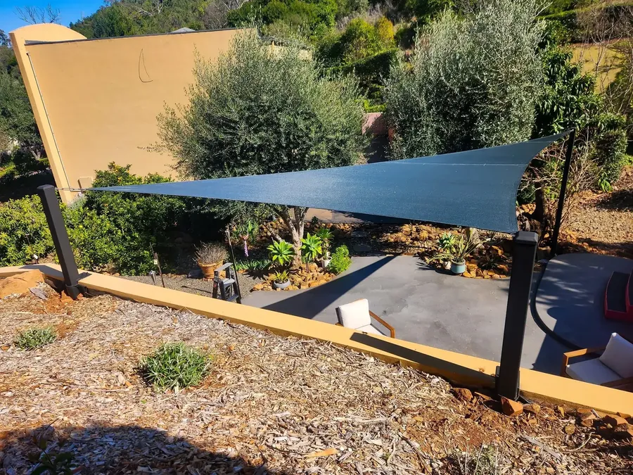 Sand-coloured shade sail above a landscaped garden path and courtyard - New England Shade Sails, Tamworth