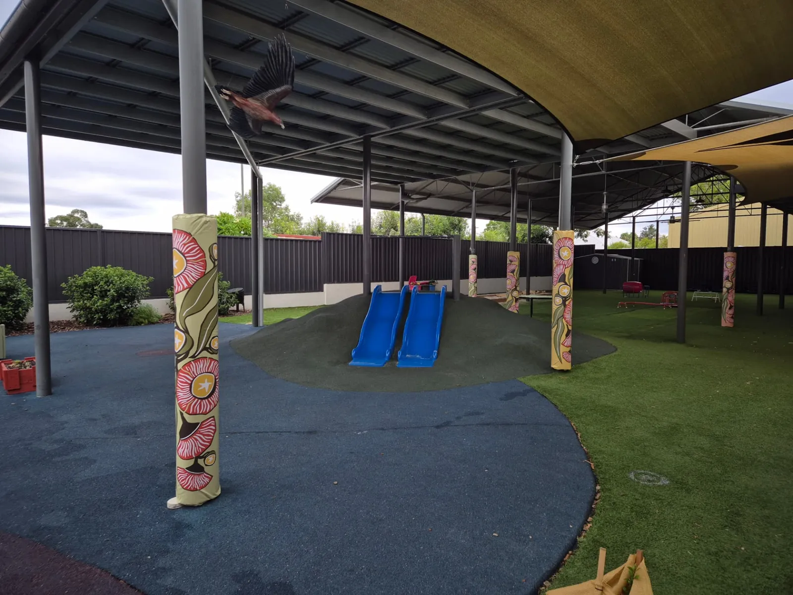 Post protection pads with a gum blossom print around childcare playground posts - New England Shade Sails, Tamworth
