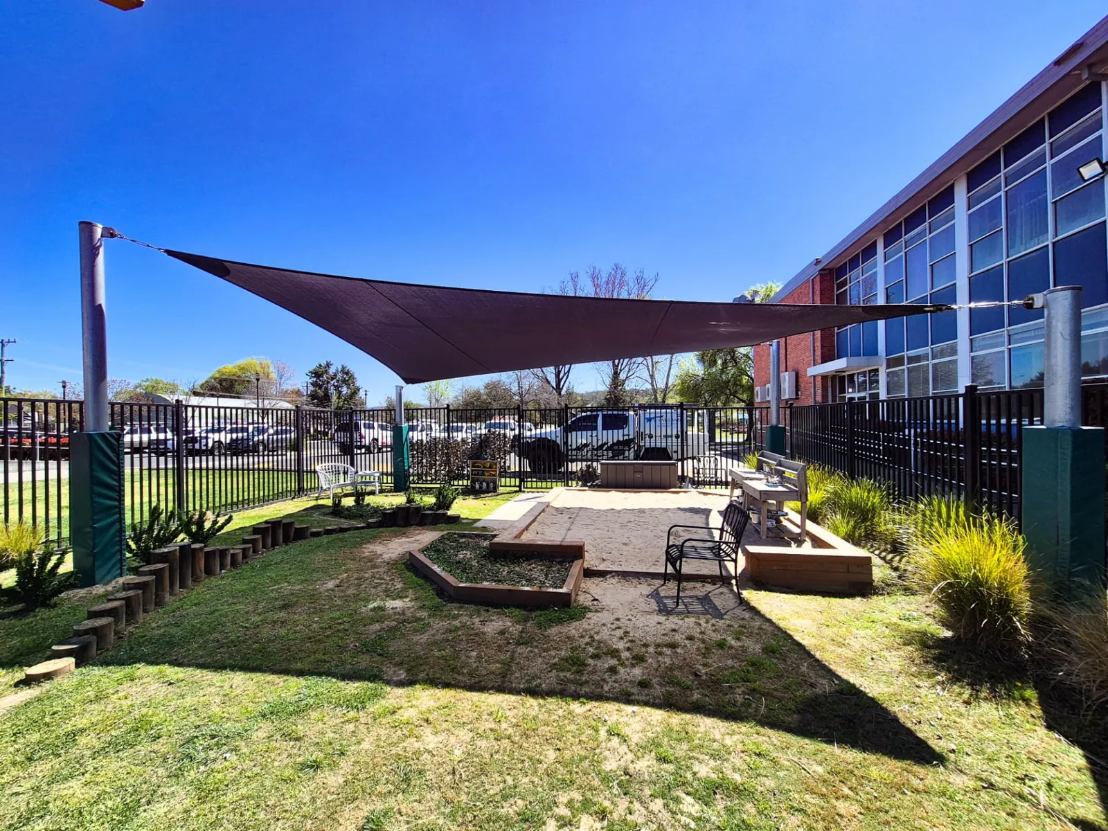 Charcoal school shade sail on padded steel posts over a sandpit and outdoor play area - New England Shade Sails, Tamworth