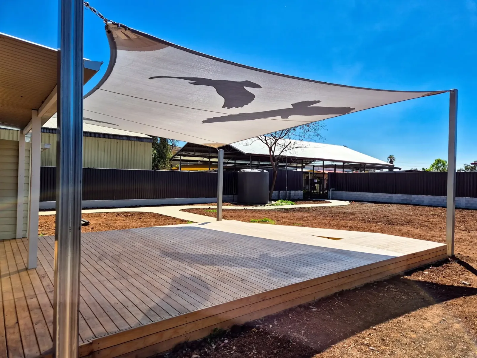 Shade sail with bird cut-out design over a timber deck at an Armidale property - New England Shade Sails, Tamworth