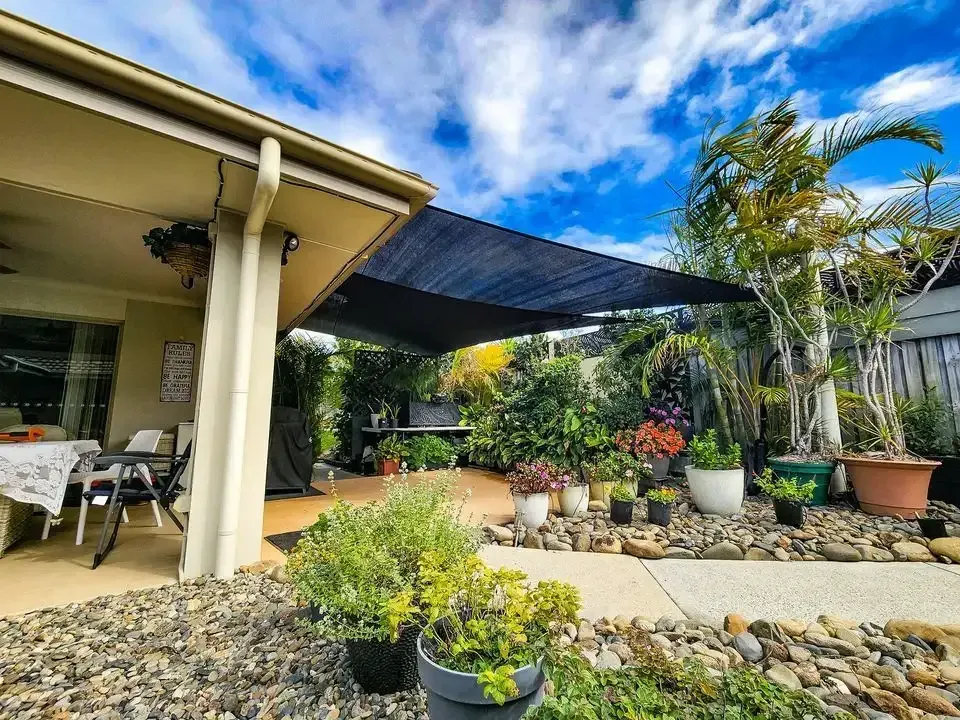 Charcoal shade sail over a paved patio and garden at a home in Manilla - New England Shade Sails, Tamworth